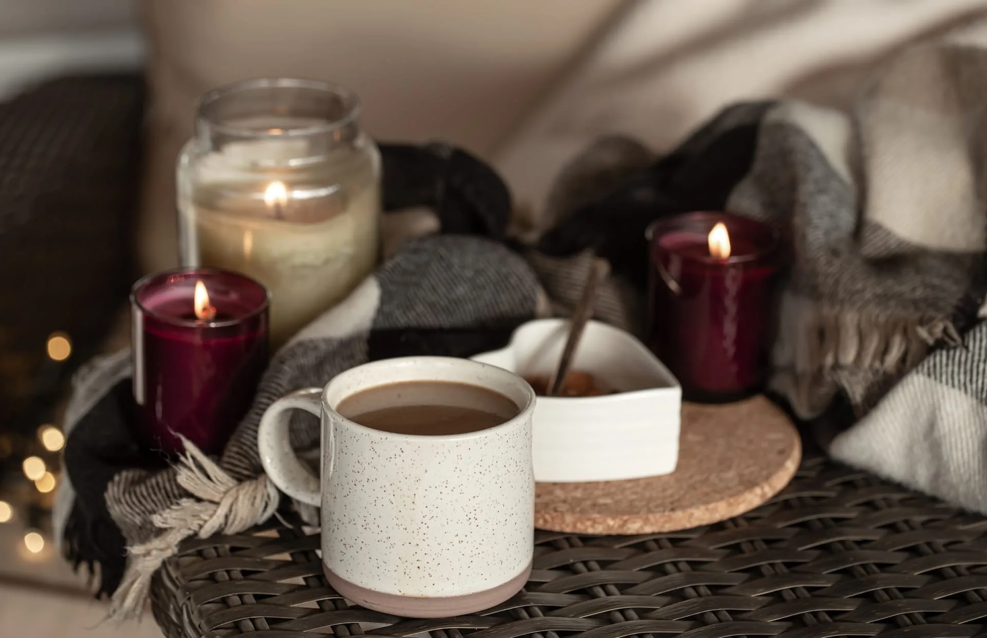Three hand-poured scented candles glowing softly on an apothecary shelf