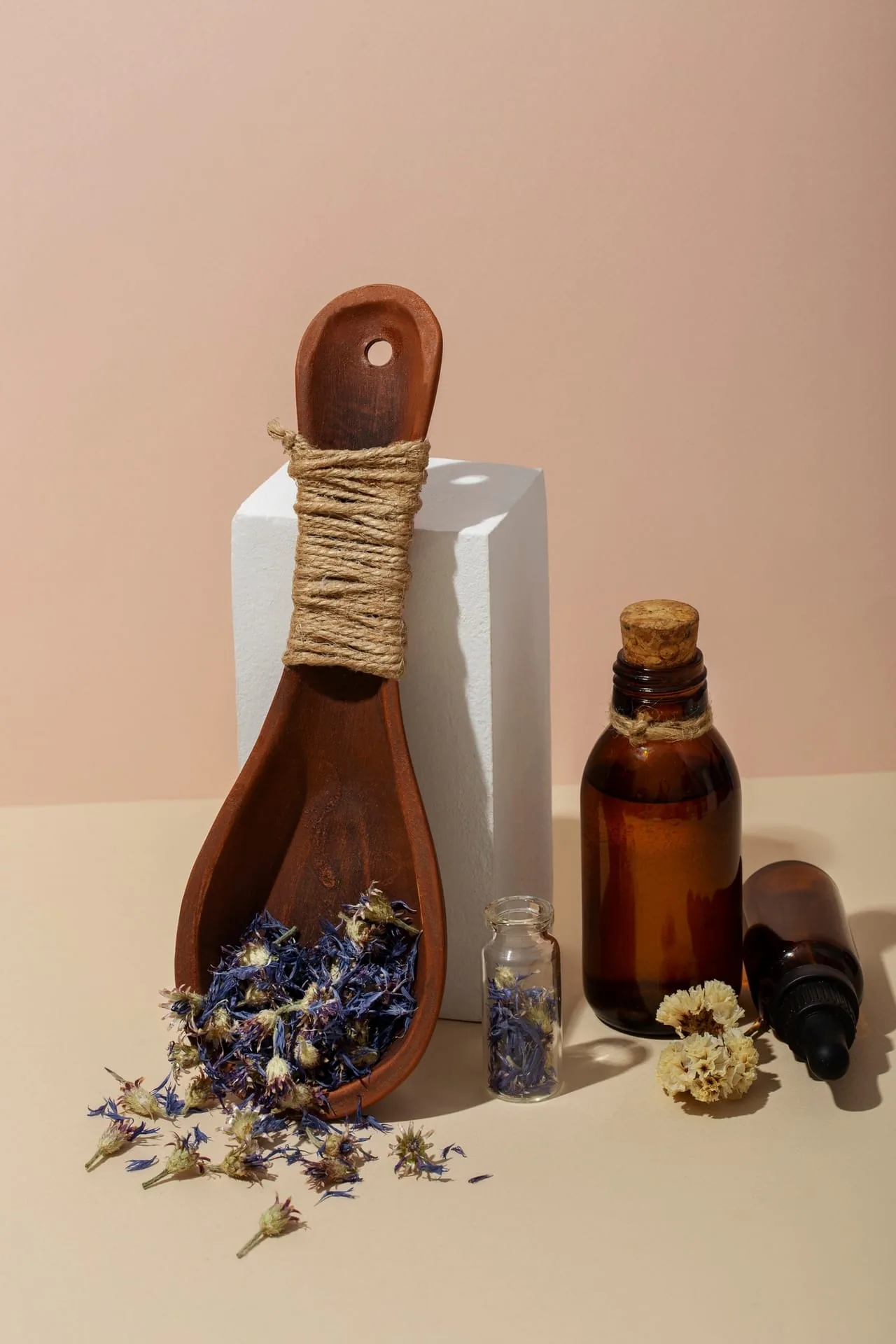 Two fragrance approaches side by side — artisan candles and amber glass